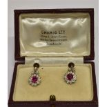 A PAIR OF MID 20TH CENTURY GOLD, RUBY AND DIAMOND CLUSTER EARRINGS with later screw fittings, each