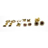 A COLLECTION OF GOLD AND GEM SET STUD EARRINGS In various designs, including; a pair of red and