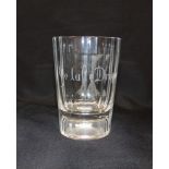 A NOVELTY GLASS BEAKER with facet cut sides, engraved 'ye laste droppe', with a man hanging from a