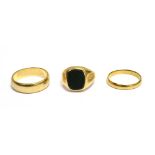 A 9CT GOLD AND BLOODSTONE SIGNET RING AND TWO GOLD WEDDING RINGS the oblong signet ring,