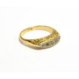 AN EARLY 20TH CENTURY GOLD AND SMALL DIAMOND FIVE STONE CARVED HALF-HOOP RING the graduated eight-