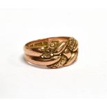 AN EDWARDIAN 9CT ROSE GOLD KNOT RING The head in the form of plain and part textured inter-woven