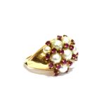 A RUBY AND CULTURED PEARL CLUSTER RING the 11 (of 13) graduated cultured-pearls arranged in three