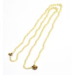 A MODERN CULTURED PEARL TWO ROW NECKLACE the beads graduated approx. 7.2mm - 3.5mm diameter, knotted