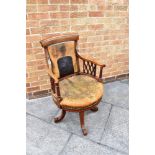 AN EDWARDIAN INLAID MAHOGANY FRAMED REVOLVING OFFICE CHAIR with leather upholstered seat and back,