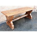 A RUSTIC OAK REFECTORY DINING TABLE the four plank top with cleated ends, on shaped supports