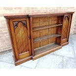 A VICTORIAN OAK BREAKFRONT BOOKCASE the central section with three adjustable shelves flanking