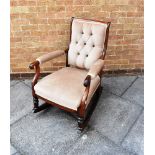 A ROSEWOOD FRAMED ROCKING ARMCHAIR with button upholstery