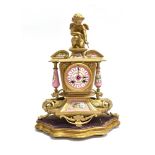 A FRENCH PORCELAIN AND GILT METAL MOUNTED MANTLE CLOCK surmounted by cherub, the 8-day movement