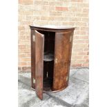 A GEORGE III BOW FRONT HANGING CORNER CUPBOARD 69cm wide 88cm high