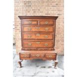 A GEORGE III OAK CHEST ON STAND with mahogany crossbanding, the moulded cornice above two short