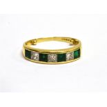 A MODERN 18CT GOLD, EMERALD AND DIAMOND SEVEN STONE HALF ETERNITY RING the four square step-cut