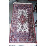 A PAIR OF RED GROUND RUGS 90cm x 175cm