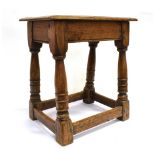 AN OAK JOINT STOOL the rectangular top 43cm x 28cm with moulded edge, plain frieze and turned