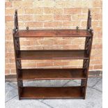 A SET OF MAHOGANY FOUR TIER HANGING SHELVES with open fret carved sides, 77cm wide 24cm deep 98cm