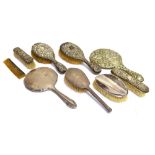 A GROUP OF SILVER MOUNTED DRESSING TABLE ITEMS comprising; two embossed oval hair brushes and