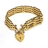 A MODERN 9CT GOLD FOUR-BAR GATE BRACELET on a heart-shaped padlock clasp, Birmingham 1979, approx.