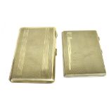 TWO EARLY 20TH CENTURY ENGINE TURNED RECTANGULAR CIGARETTE CASES each stamped 'Sterling Silver'; one