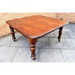 A LARGE VICTORIAN MAHOGANY EXTENDING DINING TABLE on turned supports, 136cm deep 187cm long fully