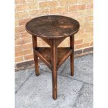 A 19TH CENTURY FRUITWOOD CRICKET TABLE the circular single plank top 48cm diameter, on triangular