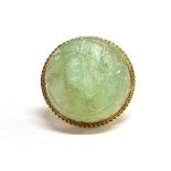 A MODERN 9CT GOLD AND CARVED EMERALD SINGLE STONE RING the pale-green round cabochon emerald approx.