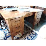 A LARGE OAK TWIN PEDESTAL DESK 137cm wide 83cm deep 75cm high