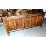 A LARGE JOINED OAK COFFER the five panel front carved 'MH 1661' to central panel, on stile feet,