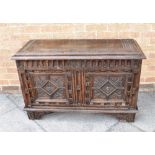 A HIGHLY CARVED OAK COFFER 109cm wide 44cm deep 70cm high