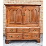 A GEORGE III OAK CUPBOARD ON STAND the upper section with moulded cornice, pair of doors each with