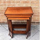 A NEST OF FOUR MAHOGANY QUARTETTO TABLES with crossbanded decoration, the largest 58cm wide 37cm