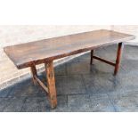 A RUSTIC OAK REFECTORY DINING TABLE the substantial three plank top on H-shaped supports, 83cm