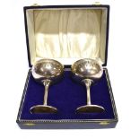 A PAIR OF MODERN SILVER GOBLETS each with a shallow round bowl with decorative sides, on a