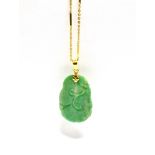 A CHINESE CARVED JADEITE PENDANT AND CHAIN the drop-shaped slightly-mottled green jadeite carved