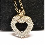 A MODERN 9CT GOLD AND DIAMOND OPEN HEART SHAPED PENDANT post 2000 London convention hallmarks;