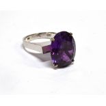 AN ORIENTAL WHITE METAL AND OVAL SYNTHETIC CORUNDUM SINGLE STONE RING the mixed-cut stone approx.