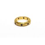 A MID 20TH CENTURY FAR EASTERN GOLD AND SAPPHIRE ETERNITY RING inset with seven small round mixed-