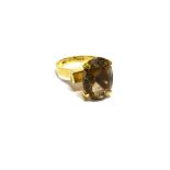 AN ORIENTAL YELLOW METAL AND OVAL CITRINE SINGLE STONE RING the mixed-cut stone approx. 16mm x 11.