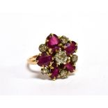 AN EARLY 20TH CENTURY GOLD, RUBY AND DIAMOND CLUSTER RING with a central old-cut diamond, approx.