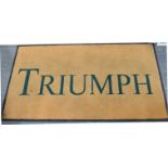 A TRIUMPH MOTORCYCLE DEALERSHIP FLOOR MAT rubber-backed, 85.5cm x 150cm.