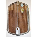 A 1939 ROVER 14 RADIATOR GRILL the grill bearing an AA car badge and one other together with an