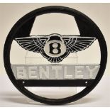 A CIRCULAR BENTLEY MOTORS ADVERTISING SIGN wheel shape, of painted heavy cast iron construction,
