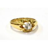 A LATE VICTORIAN 18CT GOLD SINGLE STONE GYPSY RING later set with a round near-colourless paste,