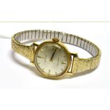 TISSOT, A LADY'S SWISS 18CT GOLD ROUND WRIST WATCH silvered dial with raised gilt baton numerals and