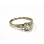 AN EARLY 20TH CENTURY DIAMOND SOLITAIRE RING WITH SMALL DIAMOND SHOULDERS the transition-cut stone