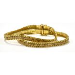 A VINTAGE ITALIAN 18CT GOLD TWO-ROW BRICK-BORDERED MILANESE BRACELET on a push snap, import marks