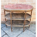 A GILT FRAMED THREE TIER SIDE TABLE with marble top and caned panels below, 81cm wide 41cm deep