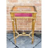 AN EDWARDIAN GILT GESSO FRAMED BIJOUTERIE TABLE 50cm x 38cm, 85cm high