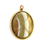 A MID VICTORIAN GOLD AND AGATE LOCKET-BACK OVAL PENDANT the banded pale-grey, white and opaque