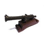 MILITARIA - A MINIATURE TABLE CANNON the cast bronze barrel 28.5cm long overall, set to a stained