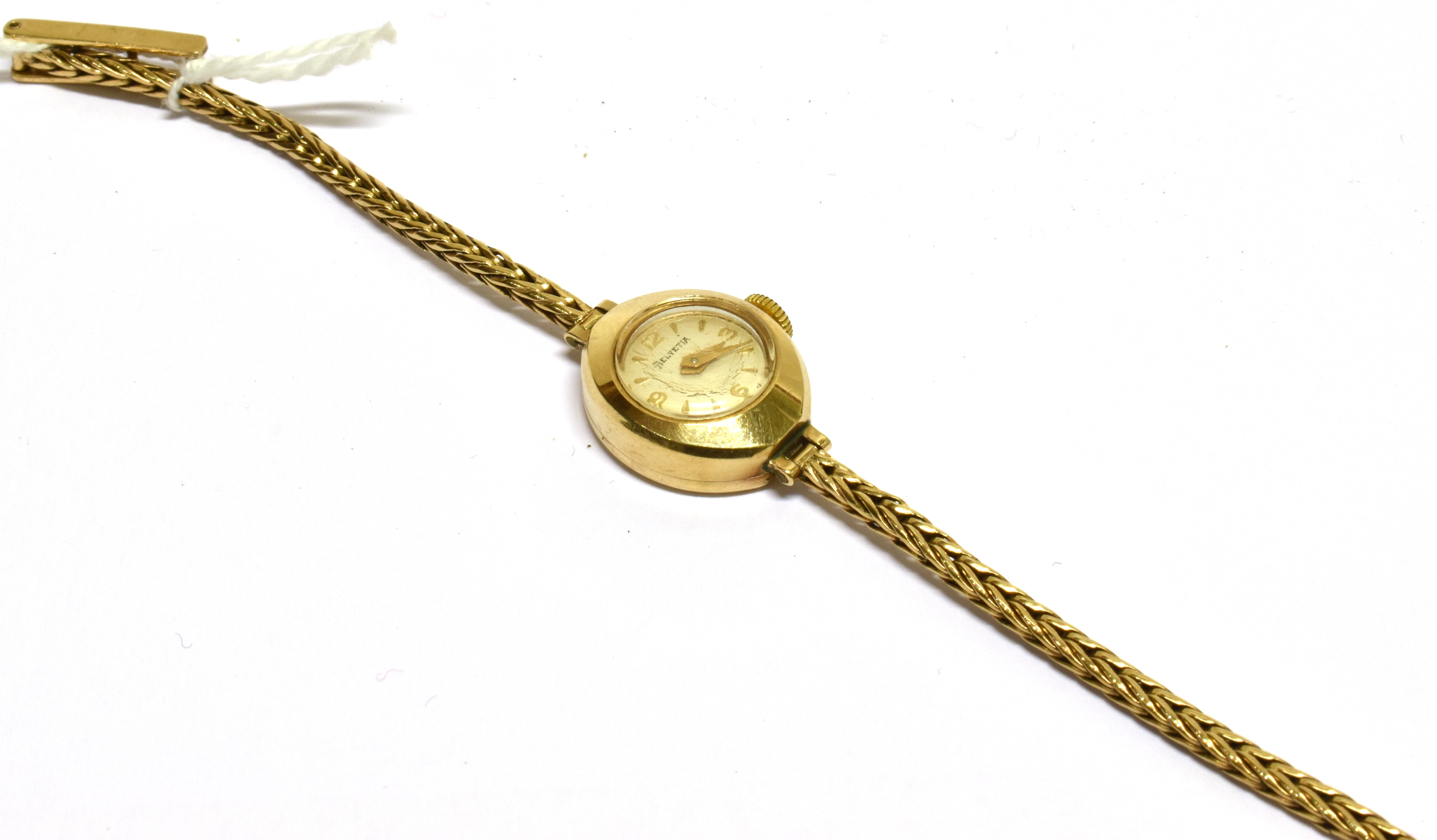 HELVETIA, A LADY'S SWISS 9CT GOLD SMALL ROUND BRACELET WATCH, CIRCA 1961 cream dial with raised gilt